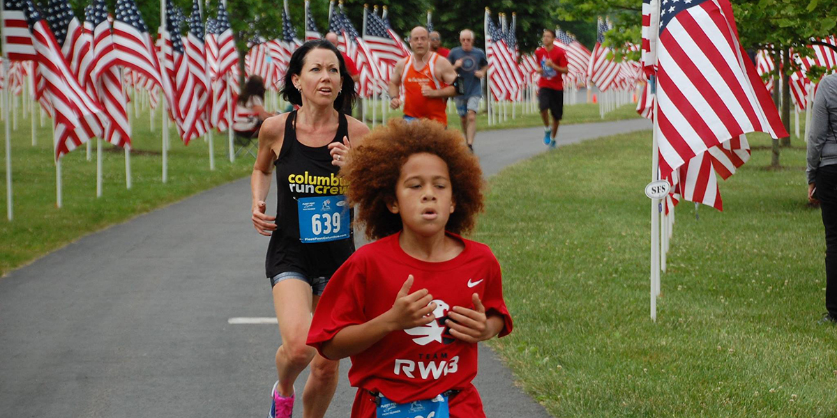 Child and woman running at the Field of Heroes 5K in westerville